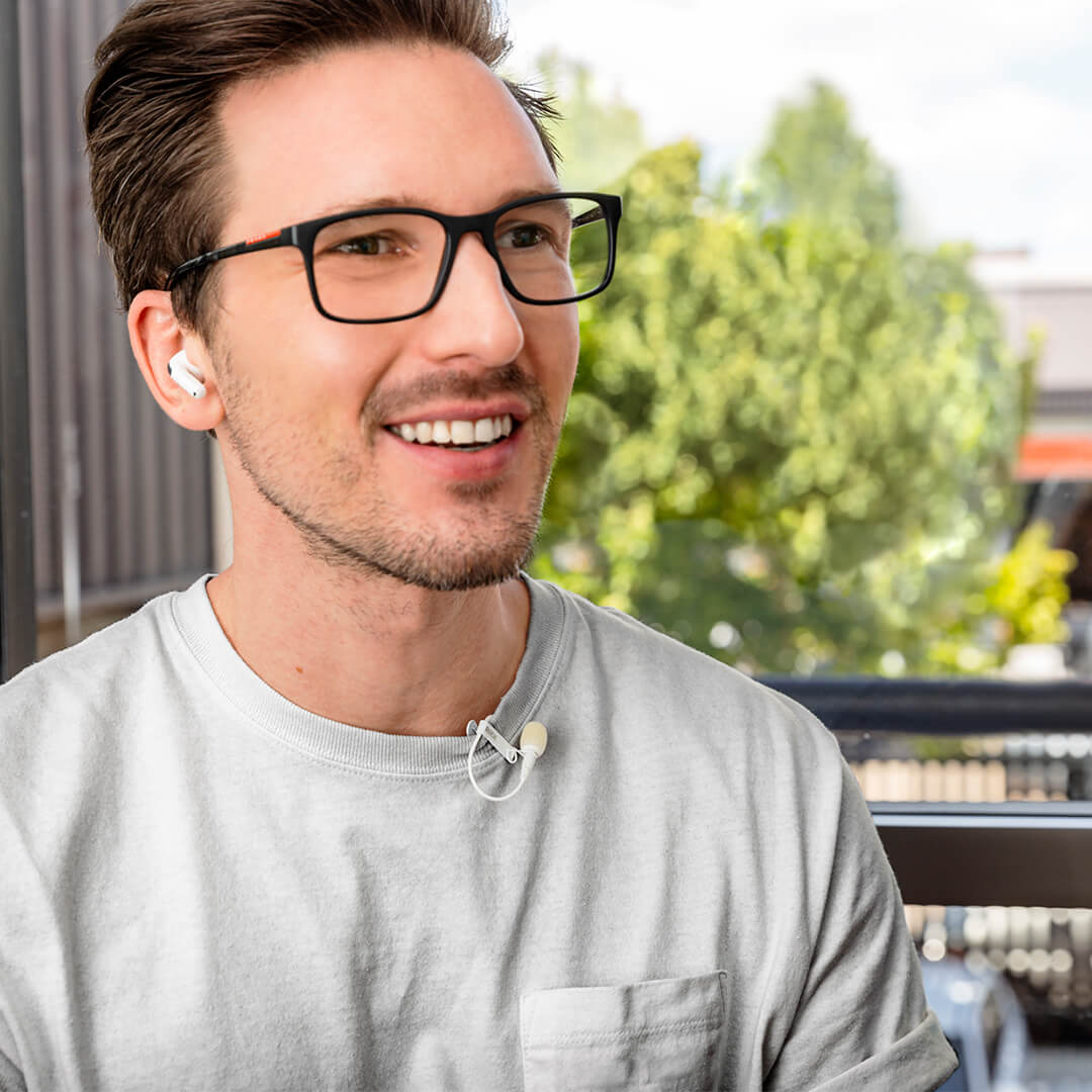 man with lavalier go white on shirt with air pods in