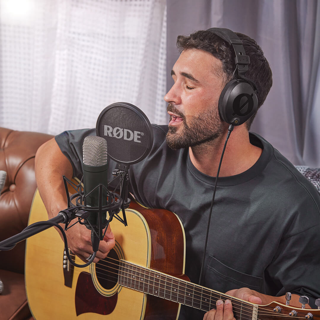 Man recording guitar and vocals with black NT1 Signature Series